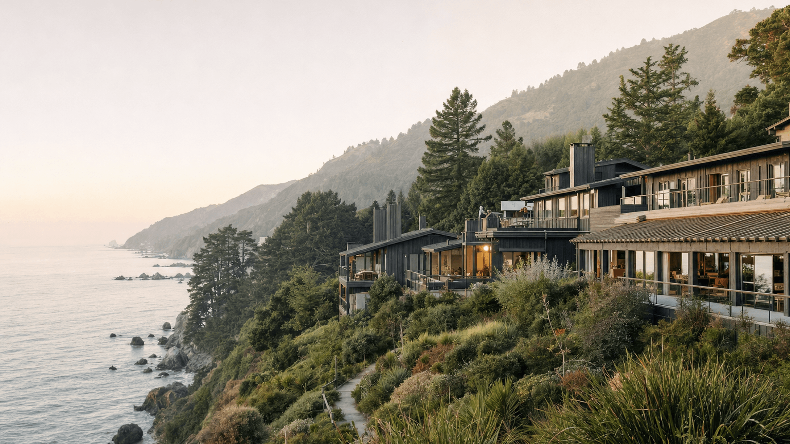 The Big Sur coastline at Aster House, with the Pacific Ocean below cliffside cypress